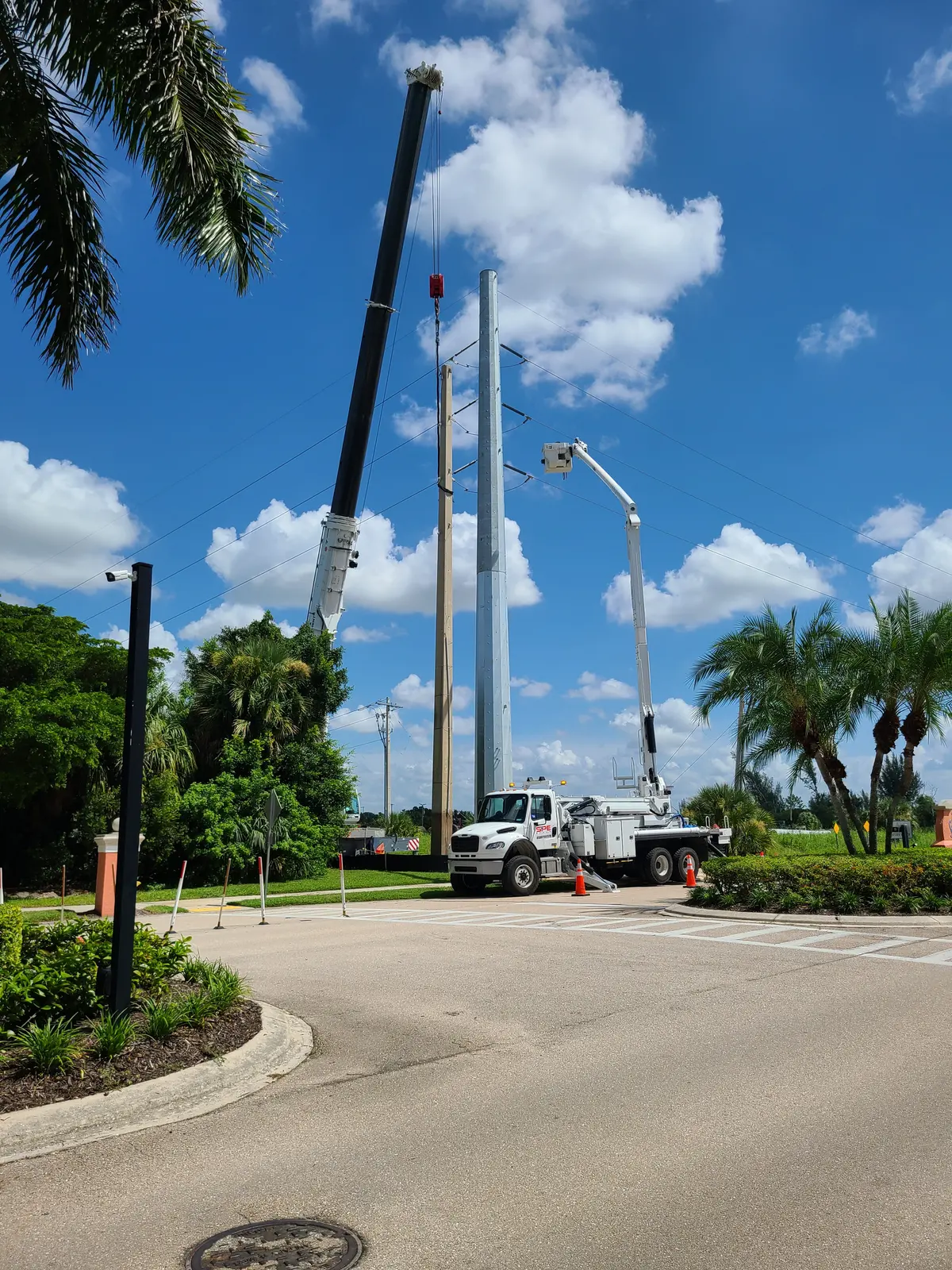 SPE crane and bucket truck crews setting a steel transmission pole