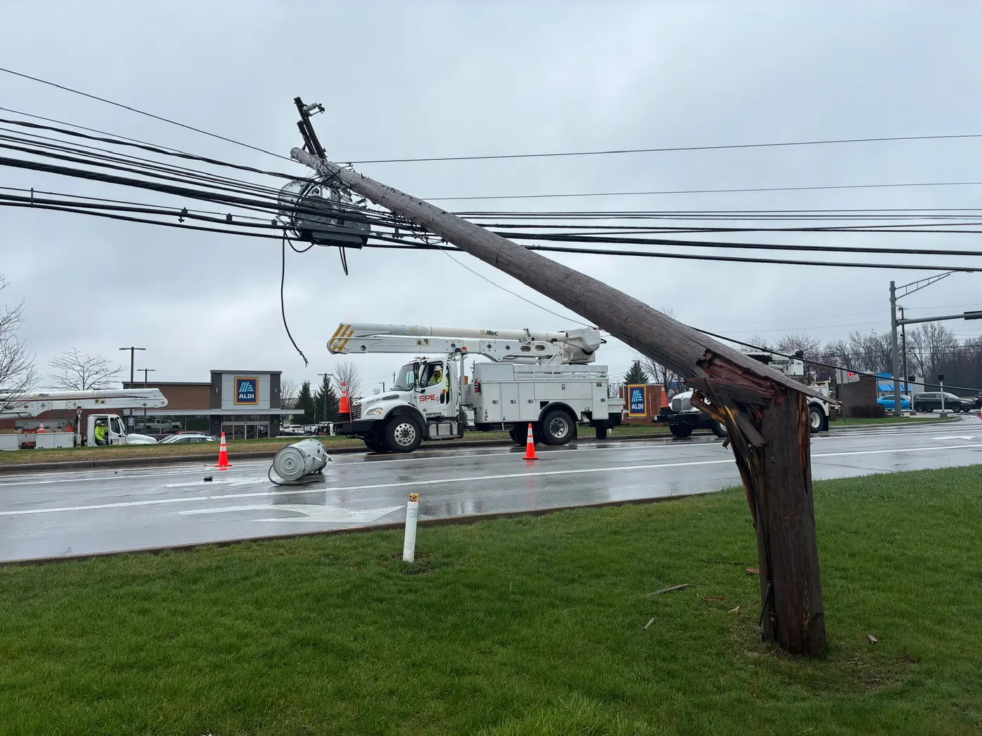 Storm-snapped utility pole with an SPE bucket truck responding