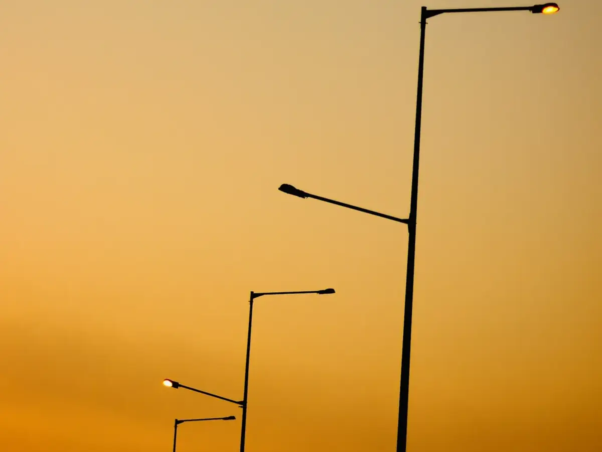 Row of roadway streetlight poles along a municipal corridor